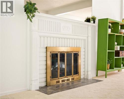 Ornate white fireplace surround with fluted pilasters and decorative molding - 351 Craigleith Drive, Waterloo, ON 