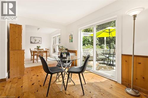 Wood-finish flooring, white walls, and a sliding glass door opening to an outdoor deck - 351 Craigleith Drive, Waterloo, ON 