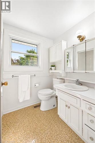 White vanity with integrated sink, chrome faucet, and cabinet storage - 351 Craigleith Drive, Waterloo, ON 