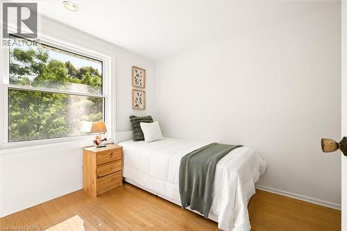 Hardwood flooring, white painted walls, single recessed ceiling light, and a single-hung window - 351 Craigleith Drive, Waterloo, ON 