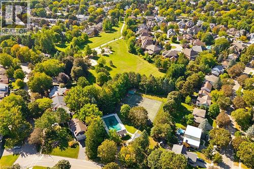 Residential area featuring mature trees, a green space, a tennis court, and a swimming pool - 351 Craigleith Drive, Waterloo, ON 
