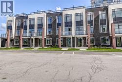Modern townhome exteriors featuring dark brick and light-toned siding - 