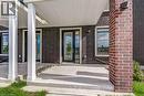 Brick exterior facade with multiple large windows and glass-panel doors - 58 Windward Drive, Grimsby, ON 