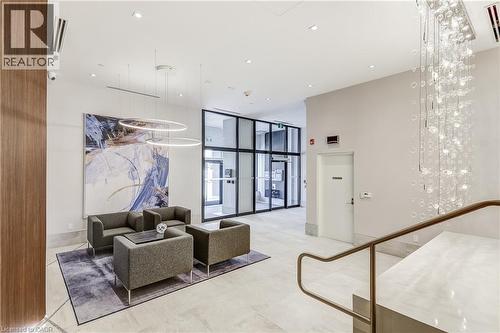 Spacious lobby featuring tile flooring, a transparent glass wall, and a multi-tiered chandelier - 58 Windward Drive, Grimsby, ON 