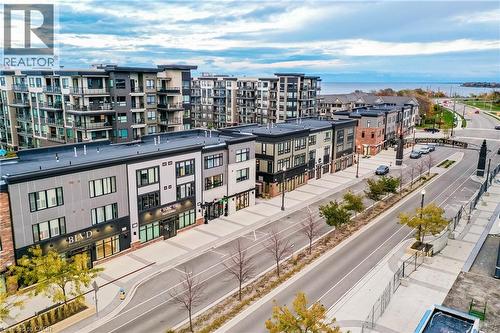 Modern multi-story buildings featuring varied facades and expansive window lines - 58 Windward Drive, Grimsby, ON 