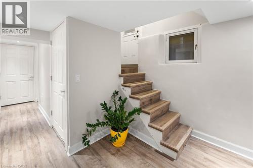 Stairway with wood finished floors and recessed lighting - 58 Hohner Avenue, Kitchener, ON 