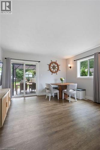 Wood-finish flooring, white walls, and a sliding glass patio door - 53 Hawtrey Road, Delhi, ON 