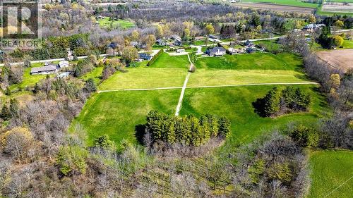 Expansive land parcel featuring open green fields and wooded areas - 47 River Road, Brantford, ON 