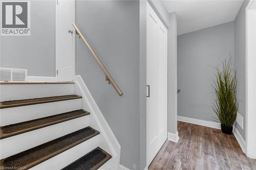 Stairs with wood finished floors and baseboards - 5 Viking Court Unit# 301, Grimsby, ON 