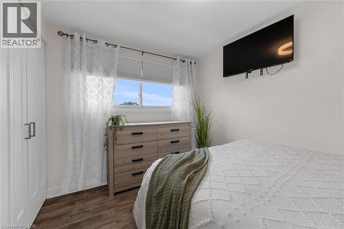Bedroom featuring dark wood-style floors - 5 Viking Court Unit# 301, Grimsby, ON 
