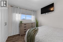 Bedroom featuring dark wood-style floors - 