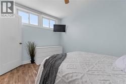 Bedroom featuring wood finished floors and a ceiling fan - 