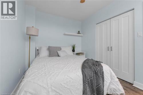 Bedroom featuring a closet, ceiling fan, and wood finished floors - 5 Viking Court Unit# 301, Grimsby, ON 