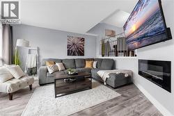 Living room with light wood-style floors and baseboards - 