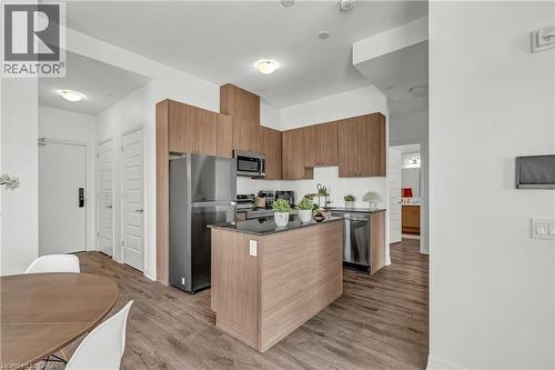 Kitchen featuring modern cabinets, stainless steel appliances, a center island, dark wood-style flooring, and wood finish cabinetry - 460 Gordon Krantz Avenue Unit# 601, Milton, ON 