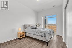 Bedroom with wood finished floors and baseboards - 