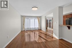 Hardwood flooring, recessed lighting, and a pass-through counter with cabinetry - 