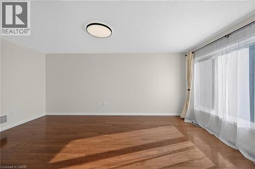 Hardwood flooring, crown molding, large window, flush mount ceiling light - 103 Emick Drive, Ancaster, ON 