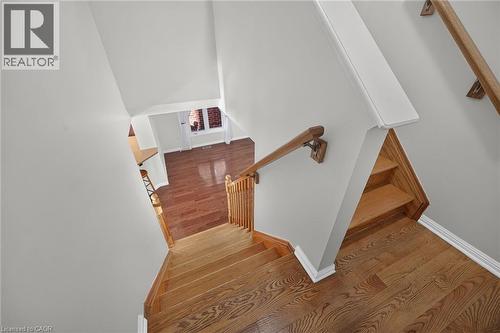 Hardwood flooring and staircase with natural wood banister - 103 Emick Drive, Ancaster, ON 