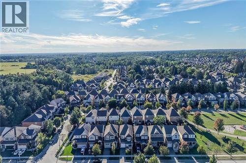 Residential neighborhood with varied architectural styles, bordered by mature trees and natural surroundings - 103 Emick Drive, Ancaster, ON 