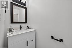White vanity with shaker-style door and drawer, featuring a white countertop with grey veining, an undermount sink, and a matte black faucet - 