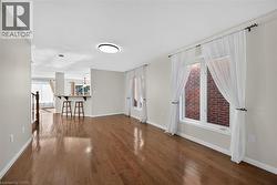 Hardwood flooring, white walls, and a breakfast bar - 