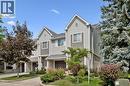 Townhome exterior featuring horizontal siding, gabled rooflines, and an attached garage - 54 Green Valley Drive Unit# 13, Kitchener, ON 