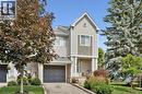 Traditional-style exterior with light gray siding, an integrated single-car garage, and a covered front entry - 54 Green Valley Drive Unit# 13, Kitchener, ON 