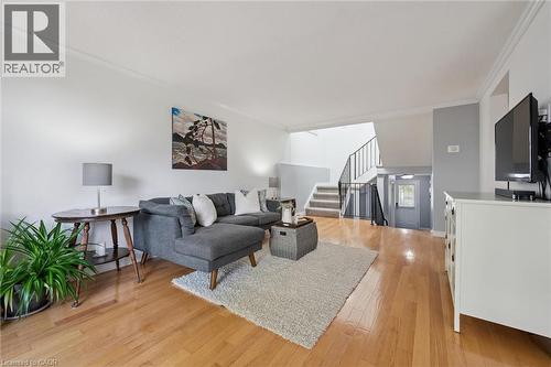 Hardwood flooring throughout, crown molding detailing, and a multi-level staircase with wrought iron railing - 54 Green Valley Drive Unit# 13, Kitchener, ON 