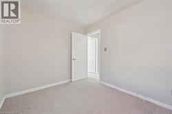 Light-colored carpeting, neutral wall paint, and a textured ceiling - 