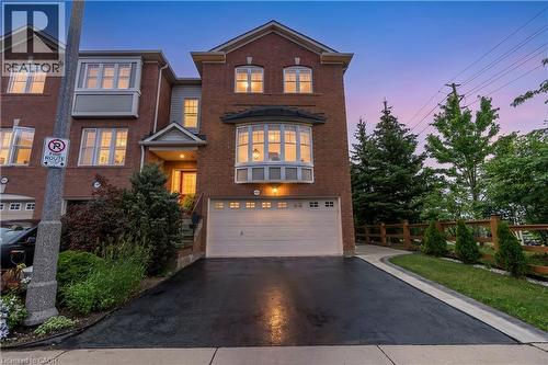 Brick exterior with a prominent bay window and an attached garage - 2435 Coho Way, Oakville, ON 