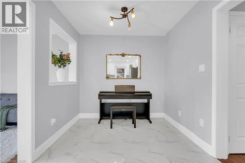 Recessed wall opening, elegant ceiling-mounted lighting fixture, light-colored walls, white trim, and polished tile flooring - 2435 Coho Way, Oakville, ON 