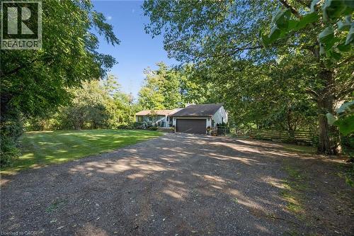 Expansive gravel driveway leading to a single-story residence with a two-car garage - 282 Concession Rd 2, Scotland, ON 