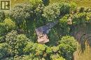 Expansive property featuring a brown shingle roof, surrounded by mature trees, and a field with a distinctive curved pattern - 282 Concession Rd 2, Scotland, ON 