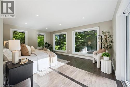 Recessed lighting, light wood-finish flooring, multiple picture windows, and a sliding glass door - 282 Concession Rd 2, Scotland, ON 