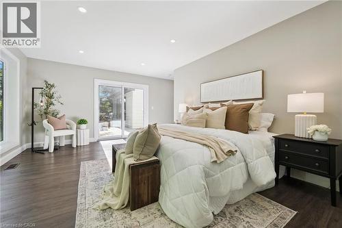 Recessed lighting, dark wood-finish flooring, light-toned walls, expansive windows, and a sliding glass door - 282 Concession Rd 2, Scotland, ON 