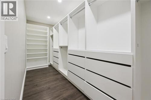 Custom closet system featuring dark wood-finish flooring, recessed lighting, and built-in shelving - 282 Concession Rd 2, Scotland, ON 