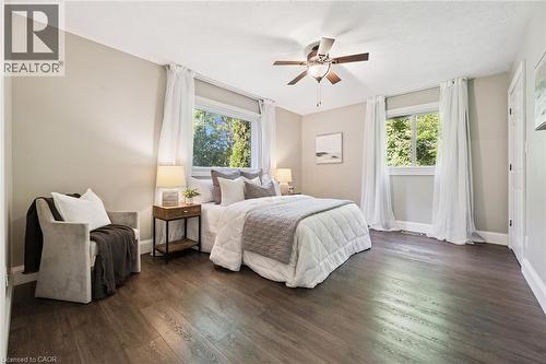 Wood-finish flooring, two windows with white trim, ceiling fan with light fixture, and light-toned walls - 282 Concession Rd 2, Scotland, ON 