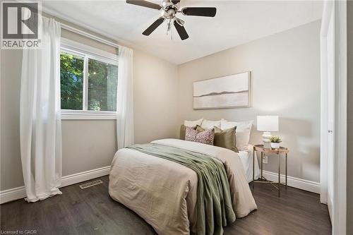 Dark wood-finish flooring, white trim, ceiling fan, white window, and light-colored walls - 282 Concession Rd 2, Scotland, ON 