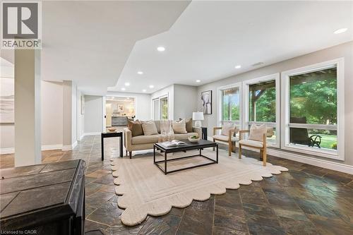 Spacious living area featuring large windows, recessed lighting, and stone tile flooring - 282 Concession Rd 2, Scotland, ON 