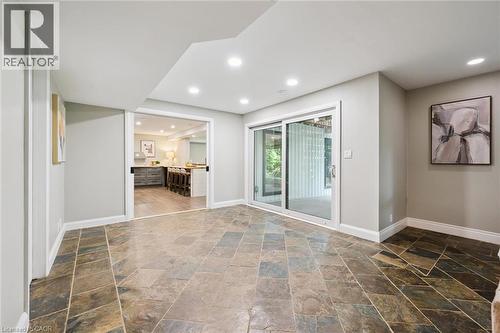 Recessed lighting, sliding glass door, natural stone tile flooring, painted walls, and white trim - 282 Concession Rd 2, Scotland, ON 