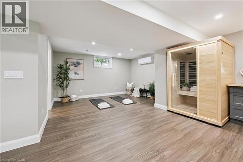 Wood-finish flooring throughout, recessed lighting, and a built-in sauna with glass door - 282 Concession Rd 2, Scotland, ON 