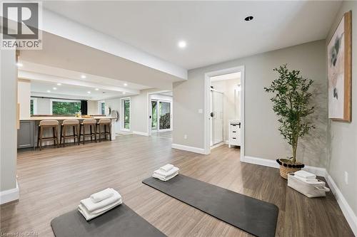 Expansive open-concept room with wood-finish flooring, recessed lighting, and a built-in bar with seating - 282 Concession Rd 2, Scotland, ON 
