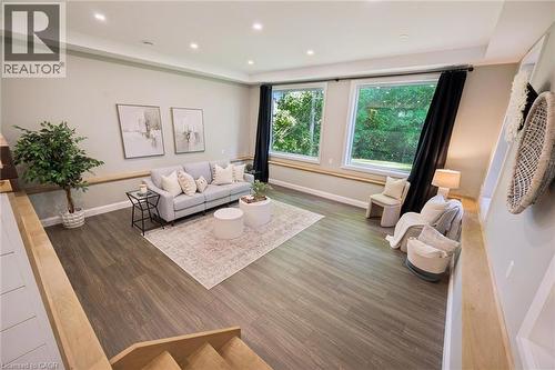 Recessed lighting, wood-finish flooring, light-toned walls, and large windows with black drapery - 282 Concession Rd 2, Scotland, ON 