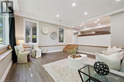 Wood-finish flooring, recessed lighting, multiple windows, a wood panel accent wall, and a staircase with wood treads - 282 Concession Rd 2, Scotland, ON 