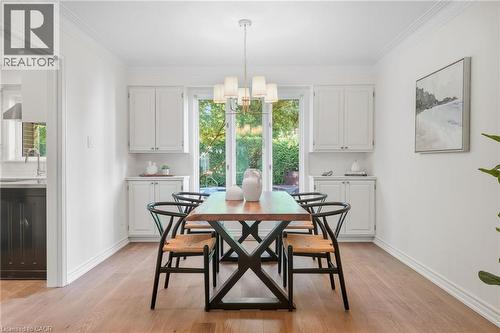Wood-finish flooring throughout, with white walls and crown molding - 4159 Spruce Avenue, Burlington, ON 