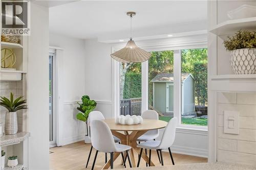 Bay window with a pendant light fixture, wood-finish flooring, and built-in shelving - 4159 Spruce Avenue, Burlington, ON 