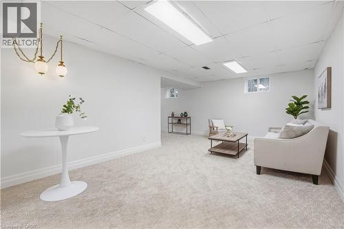 Finished lower level featuring recessed lighting, plush carpeting, and multiple windows providing natural light - 4159 Spruce Avenue, Burlington, ON 