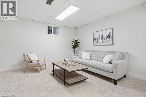 Recessed lighting, light-toned carpeting, and a window for natural illumination - 4159 Spruce Avenue, Burlington, ON 