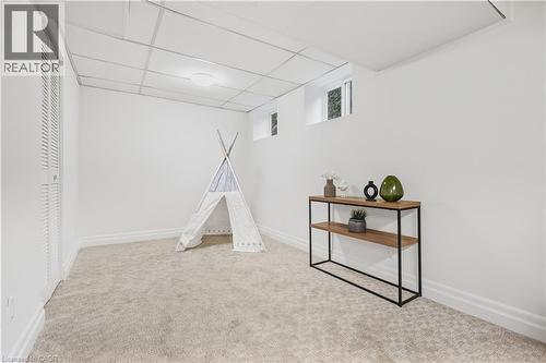Recessed lighting illuminates the dropped ceiling and light-toned carpeting - 4159 Spruce Avenue, Burlington, ON 